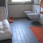 Pavimento bagno con formella 17x54 in gres naturale grigio.